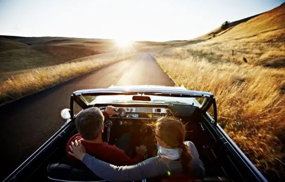 Couple enjoying sunset drive, ideal for good driver and multi-car discounts